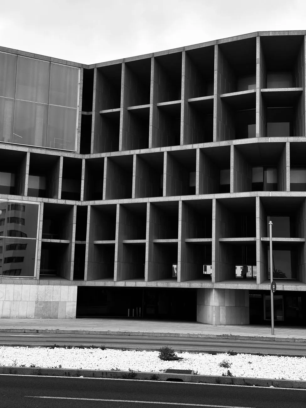 Black-and-white geometric concrete facade — structure as a first principle.